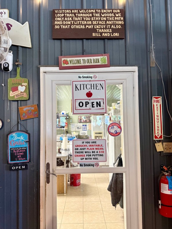 The entrance to the farm kitchen covered with cheerful stickers and signs.