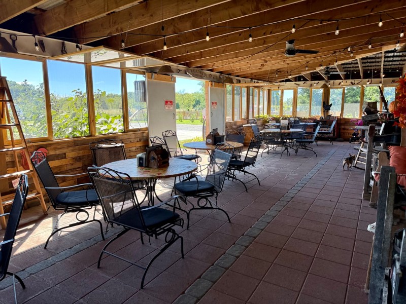 A spacious covered patio with tables for enjoying lunch at the farm.