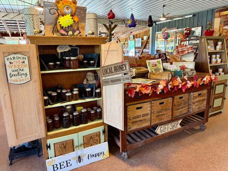 Rustic shelves filled with locally made goods and autumn decorations.